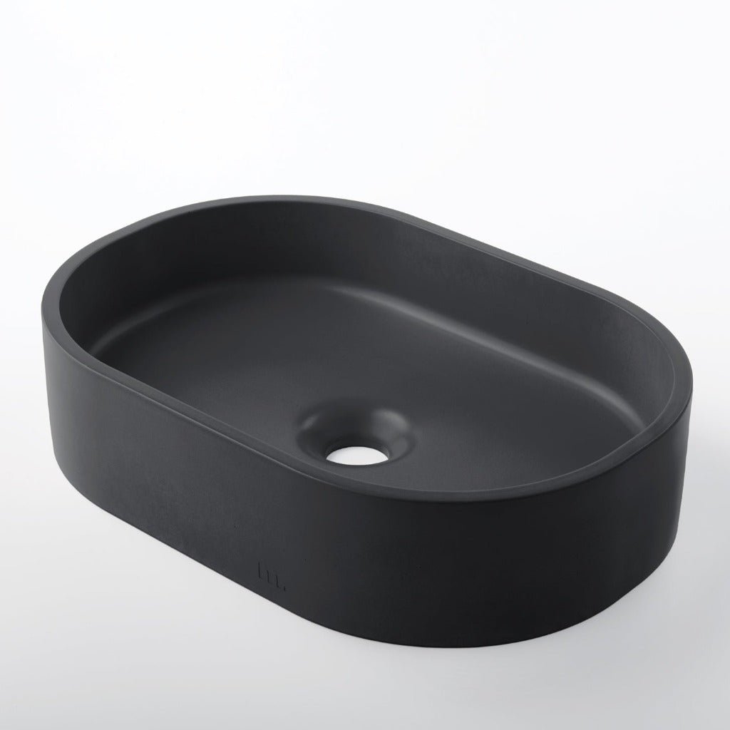A Parro Basin SM by mudd. concrete sitting on top of a white counter.