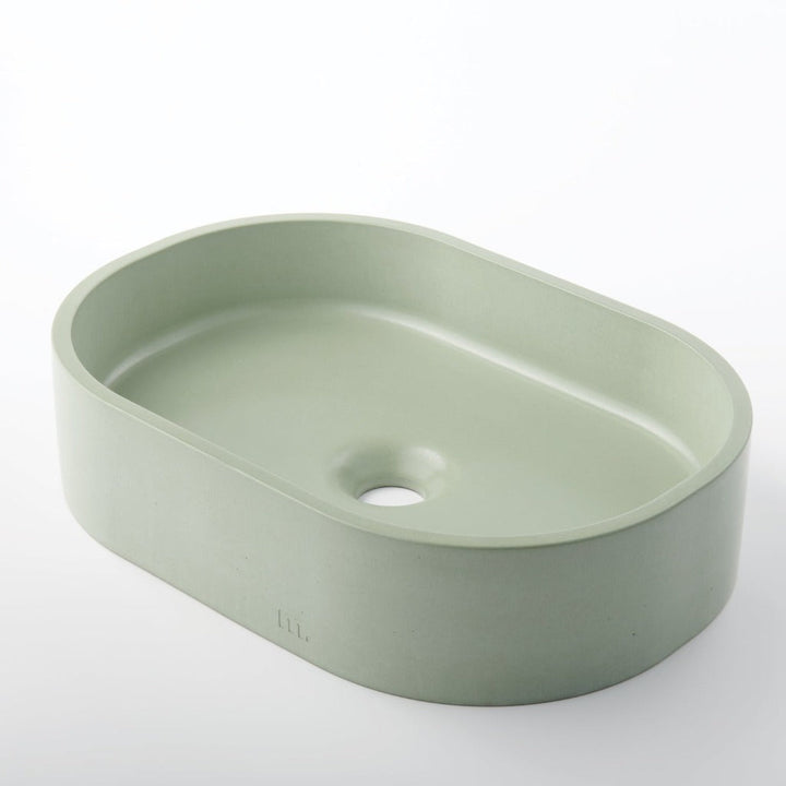 A Parro Basin SM sink with a hole in the middle of it from mudd. concrete.