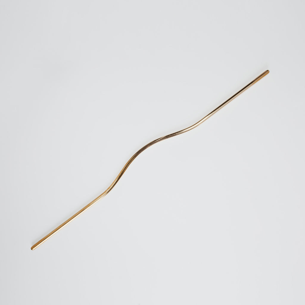 Elegant long brass line handle with the grip facing up.