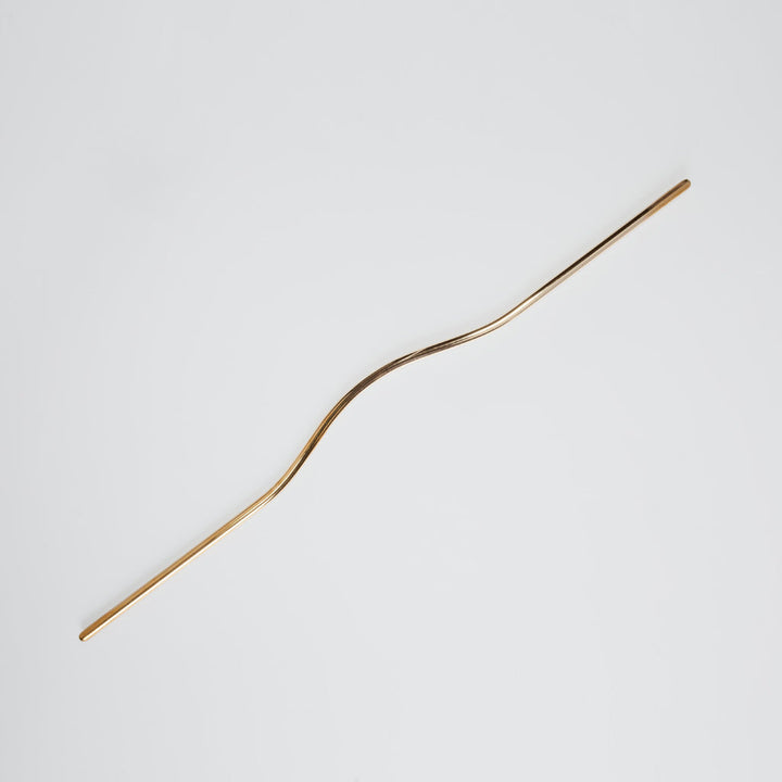 Elegant long brass line handle with the grip facing up.