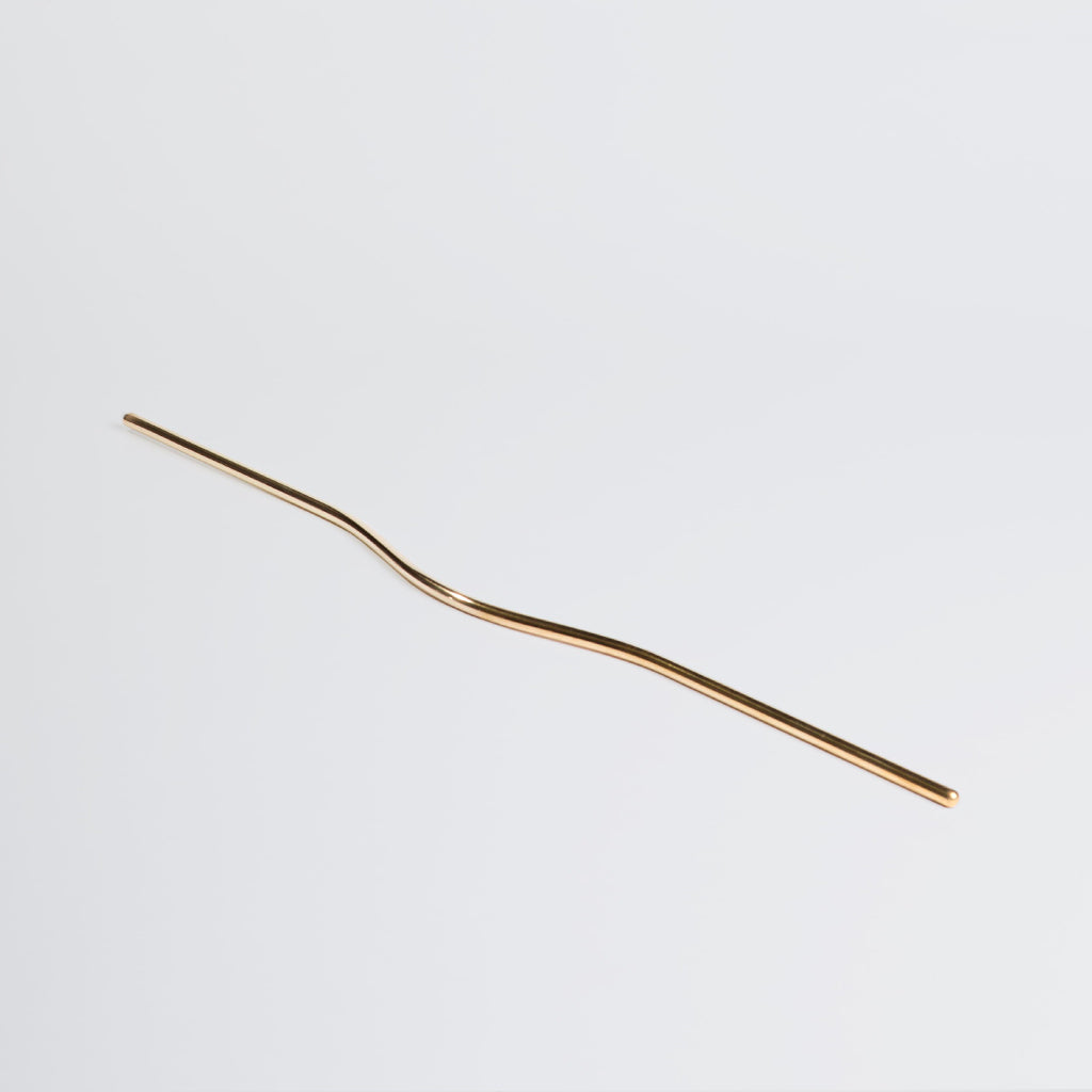 Elegant long brass line handle with the grip facing down.