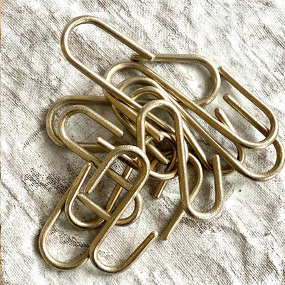 A pile of Pyra S Hooks by Shayne Fox sitting on top of a table.
