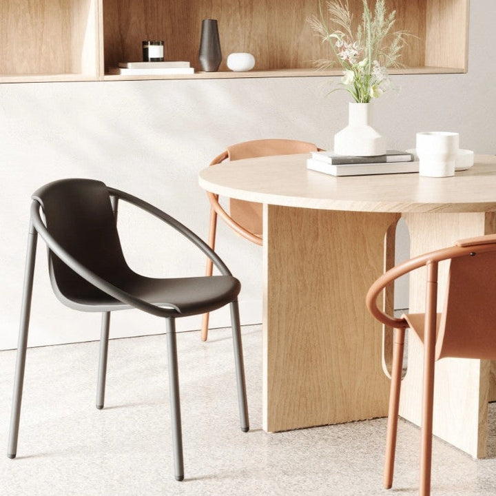 A table with two Umbra Ringo Chairs and a vase on it.
