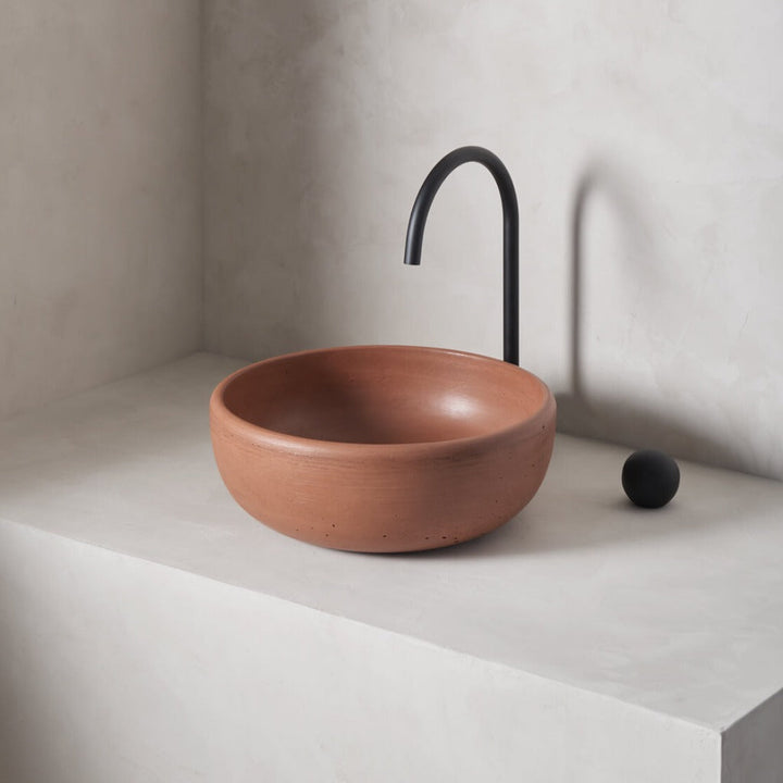 A modern and circular washbowl with softened curves and high, round-over basin walls