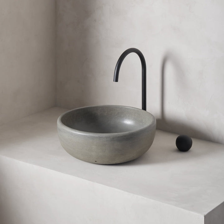 A modern and circular washbowl with softened curves and high, round-over basin walls