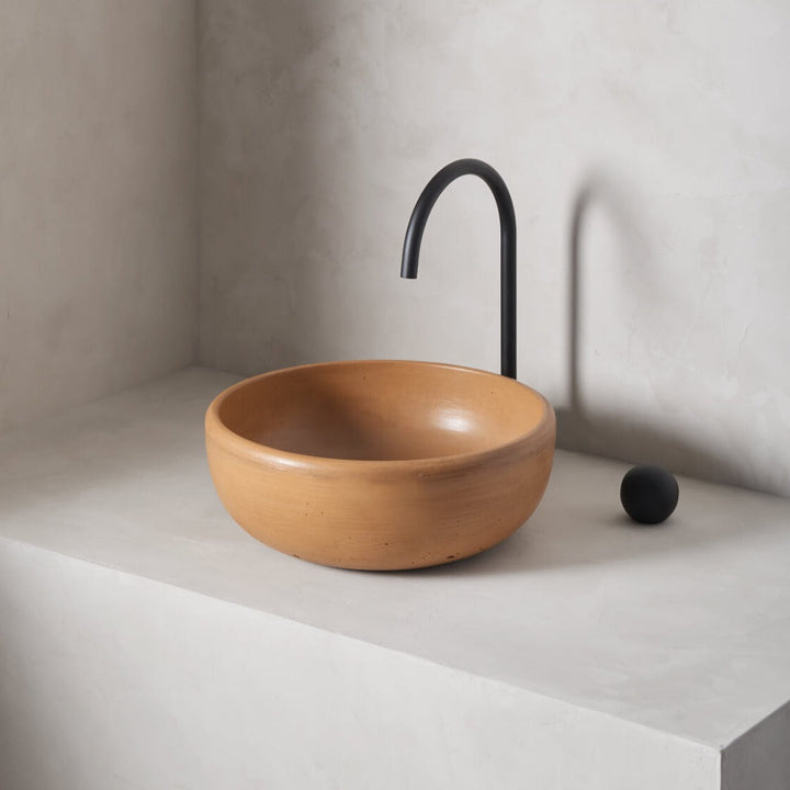 A modern and circular washbowl with softened curves and high, round-over basin walls