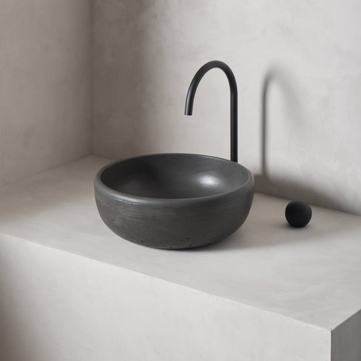 A modern and circular washbowl with softened curves and high, round-over basin walls