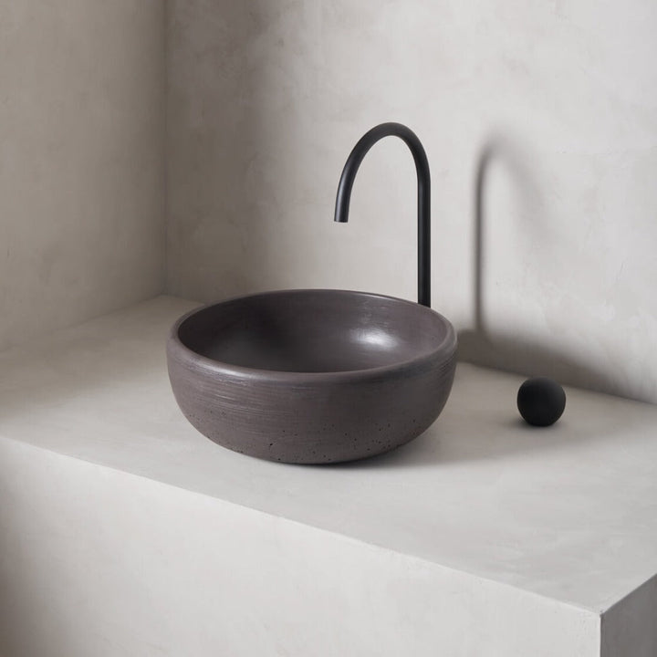 A modern and circular washbowl with softened curves and high, round-over basin walls
