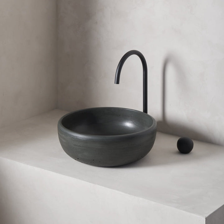 A modern and circular washbowl with softened curves and high, round-over basin walls