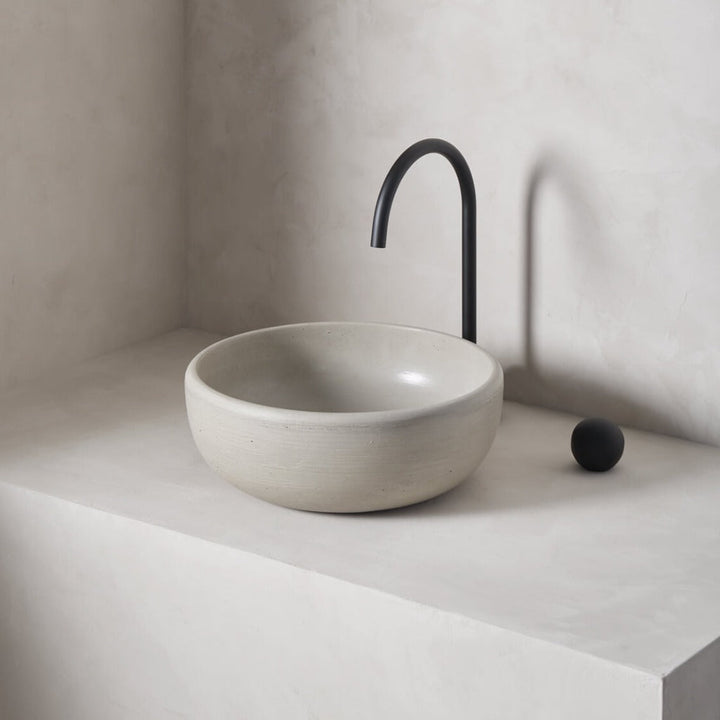 A modern and circular washbowl with softened curves and high, round-over basin walls