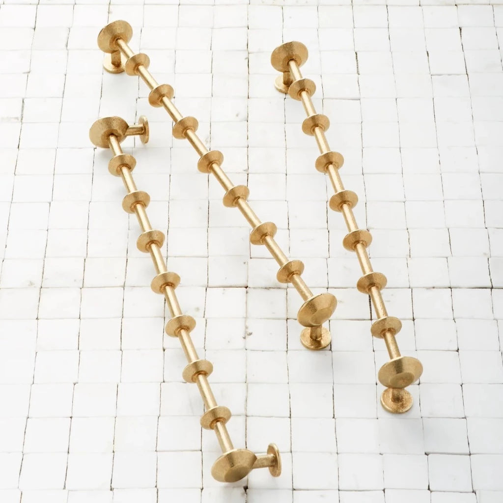 SPUL Handles in satin brass on tile surface