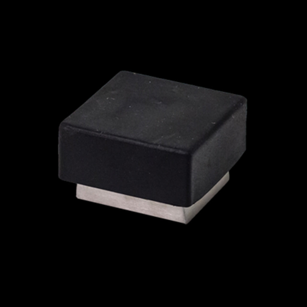 A black and silver AHI Square Door Stop on a black background.