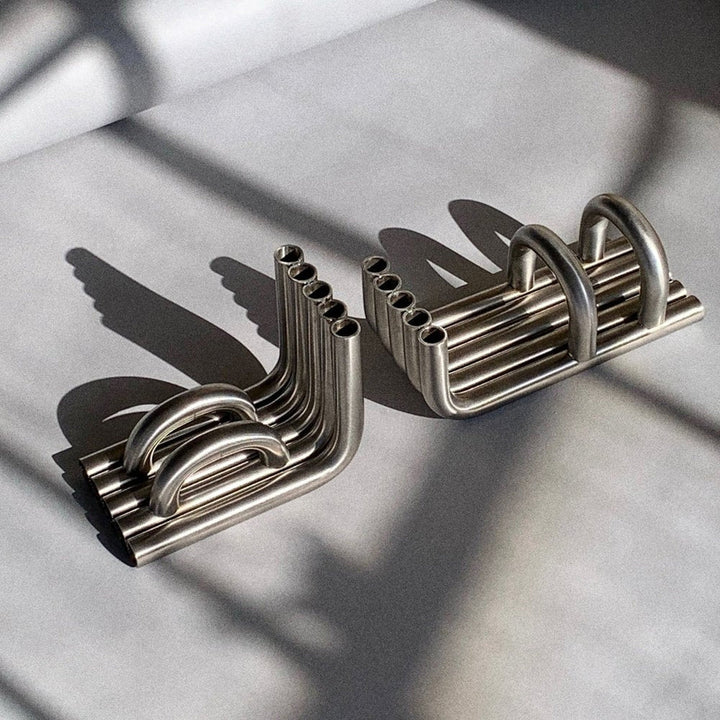 Stainless Steel TUBE bookends in a white background with long shadows