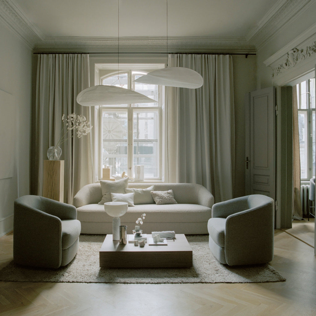A living room lit by New Works Tense pendant lamps.