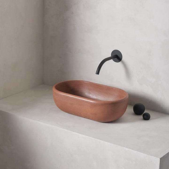 A petite and obround washbowl with softened curves and high, round-over basin walls