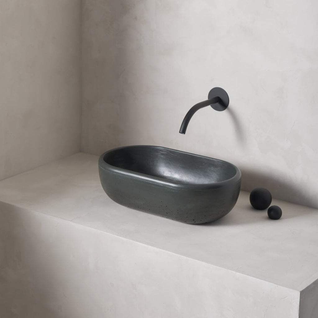 A petite and obround washbowl with softened curves and high, round-over basin walls
