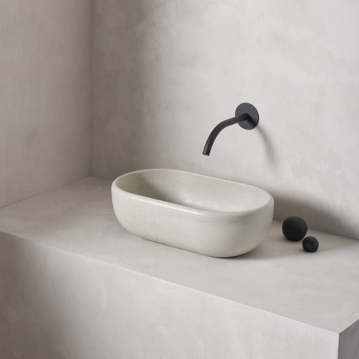 A petite and obround washbowl with softened curves and high, round-over basin walls