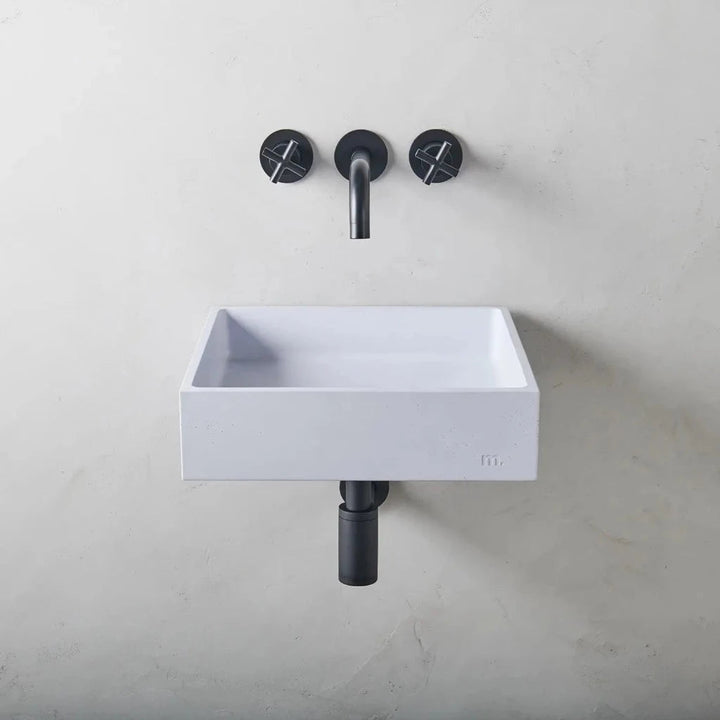 A mudd. concrete Yarra Basin LG Affix sink sitting next to a faucet on a wall.