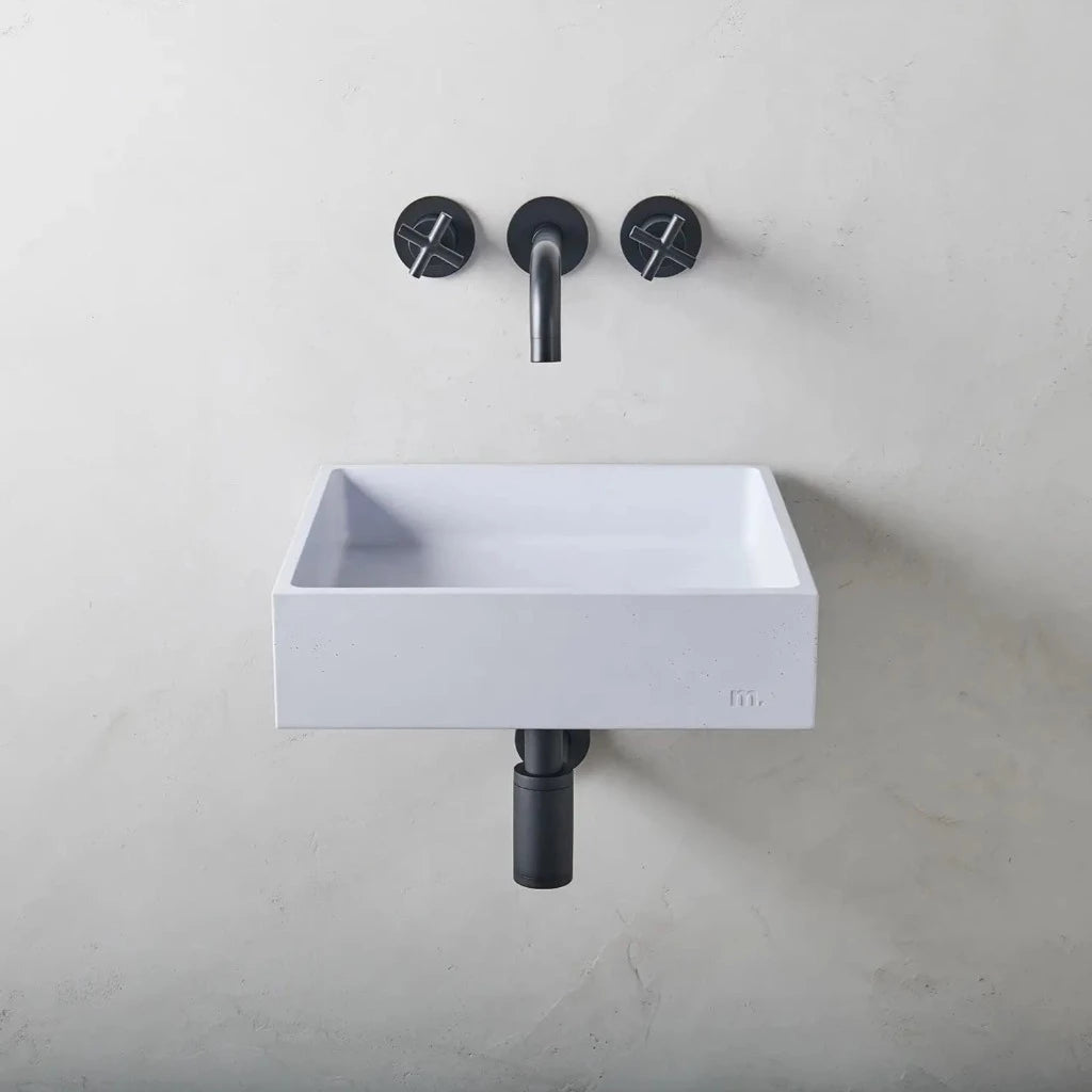 A mudd. concrete Yarra Basin LG Affix sink sitting next to a faucet on a wall.