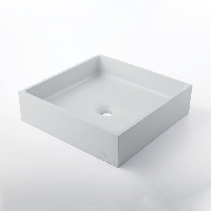 A white Yarra Basin LG sink on a white mudd. concrete surface.