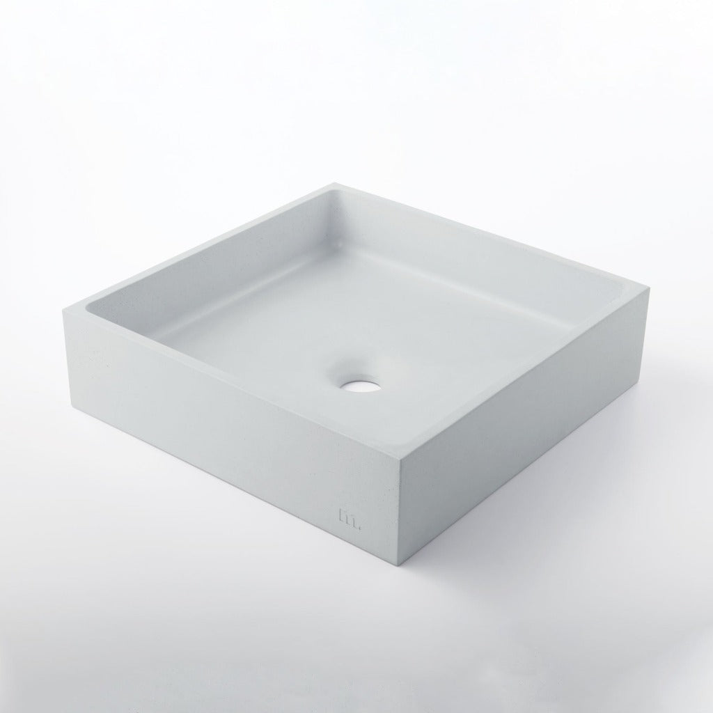 A white Yarra Basin LG sink on a white mudd. concrete surface.