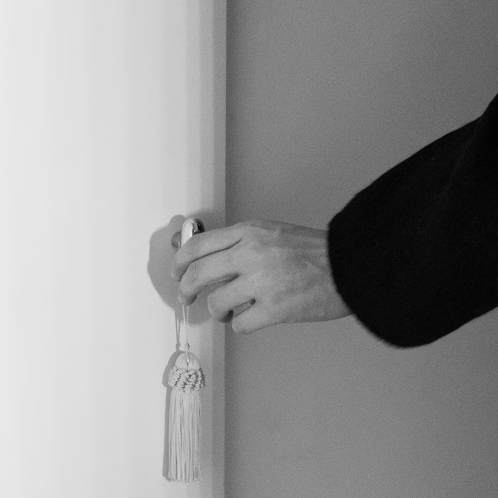 Black and White Image of a Hand Holding Door Knob