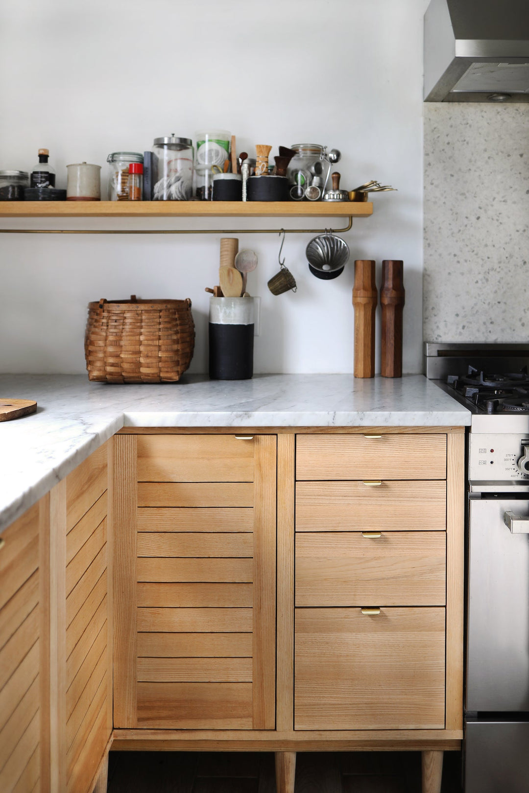 Warm and Modern Kitchen Design with Casson Hardware Charlie Tab Pulls in Brass.