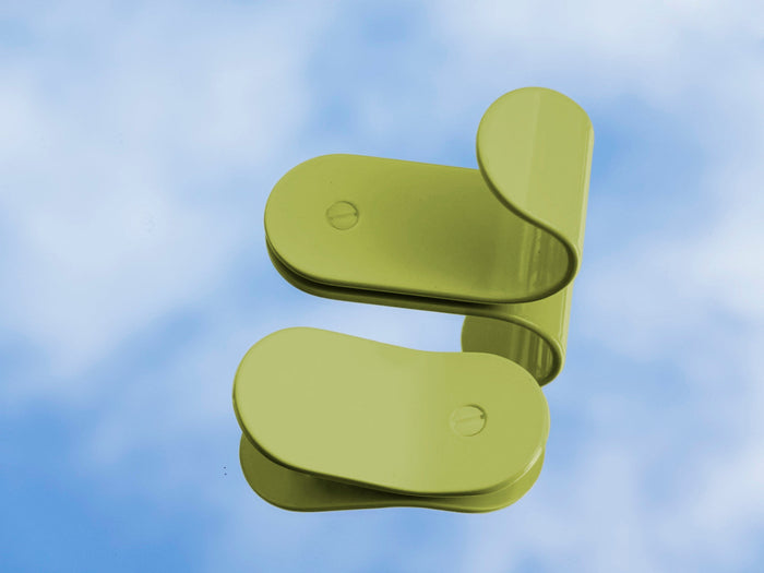 grass green wall hooks on a mirror reflecting sky 