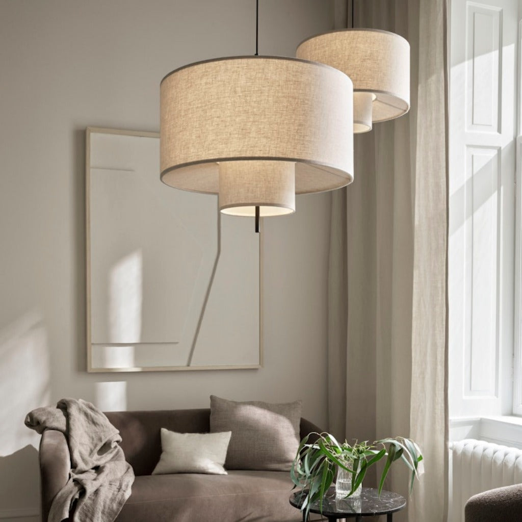 Two round, tiered pendant lamps hung from ceiling