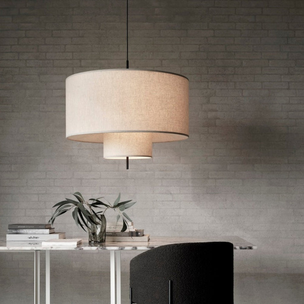 A round, tiered pendant lamp hung from ceiling
