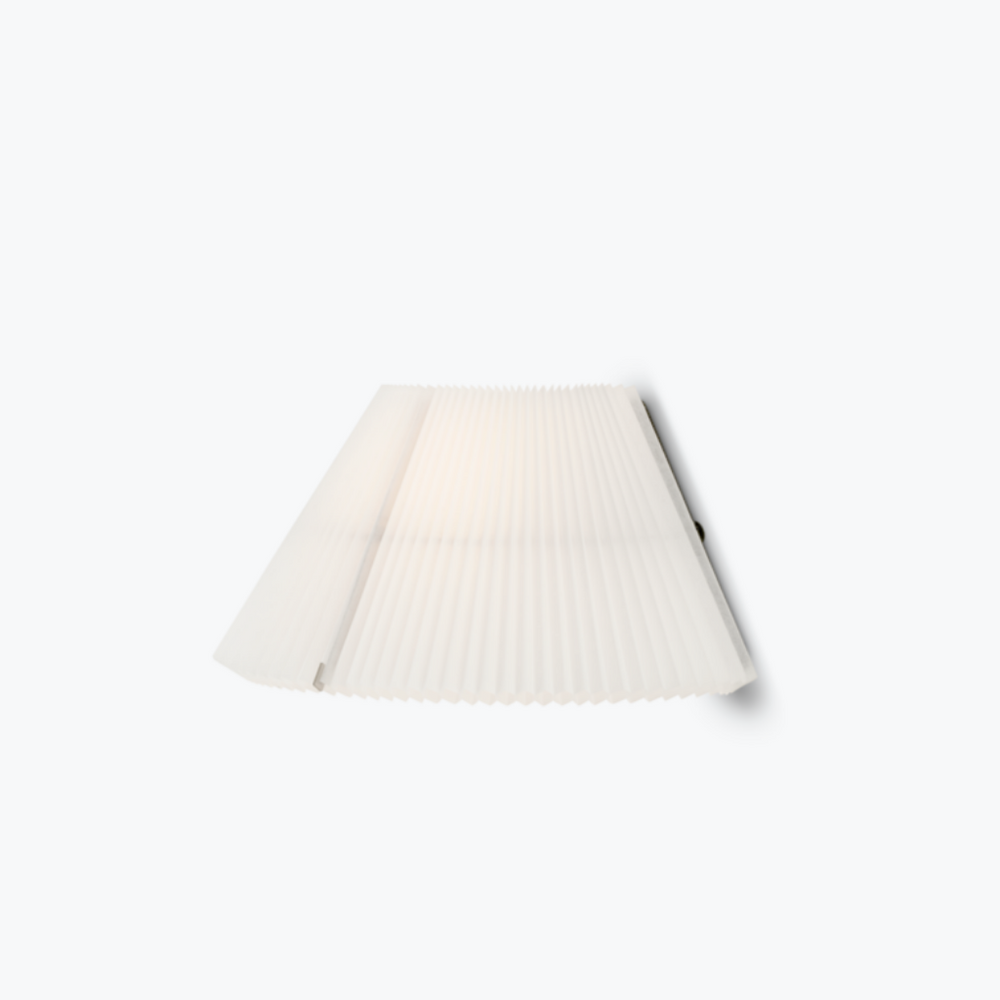 A white, pleated wall lamp