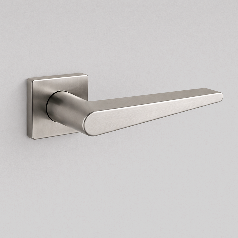 Satin stainless steel AHI 135 door lever, an angular flat lever on a square rose.