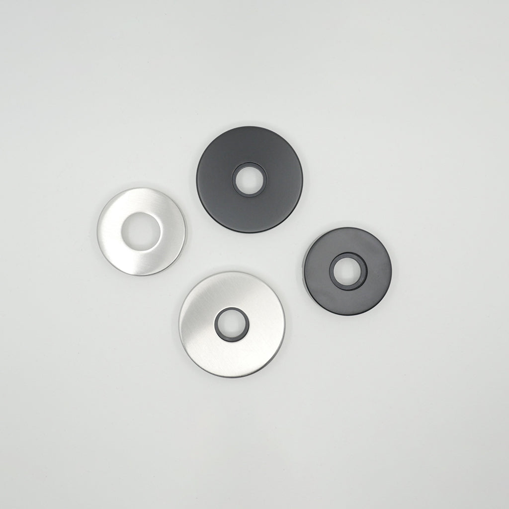 A group of three AHI Door Lever No. 104 Passage discs sitting on top of a table.