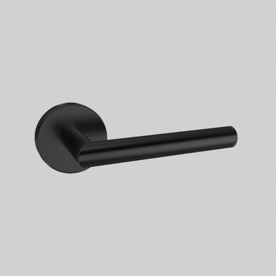 An AHI Door Lever No. 104 Privacy handle on a gray wall.