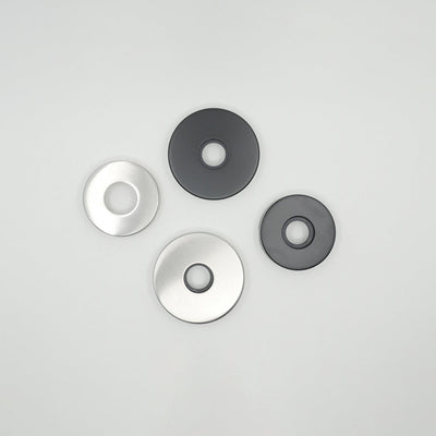 A group of three AHI Door Lever No. 105 Passage discs sitting on top of a table.