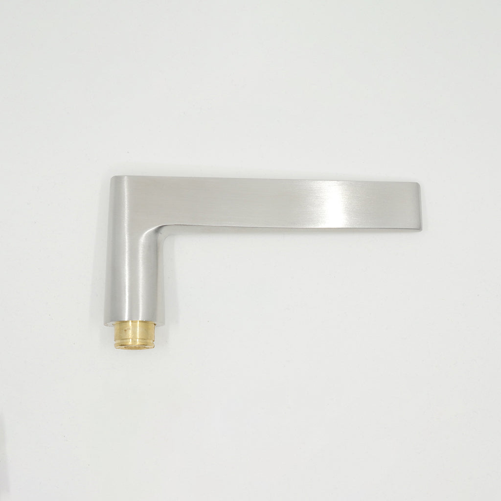 A close up of an AHI Door Lever No. 135 Privacy on a white wall.