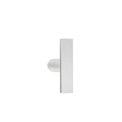 An ARC Cabinet Knob by Formani on a white wall.