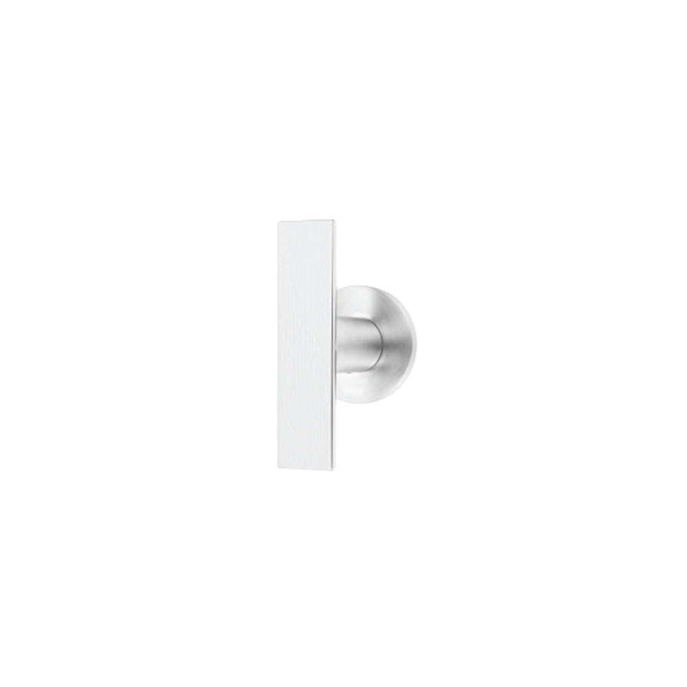 An ARC Cupboard Knob by Formani on a white wall.