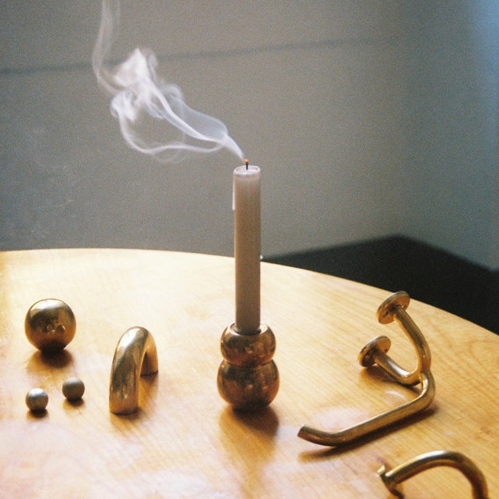 Anjou Candleholder and other bronze hardware set on wood table display