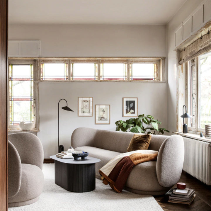 A living room filled with Ferm Living furniture and windows, illuminated by the Arum Floor Lamp.