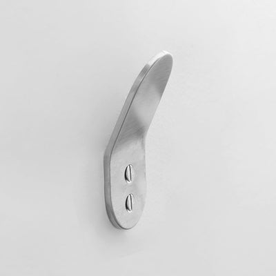 A close-up of a BENDE Angle Hook door handle on a white wall by CSSN.