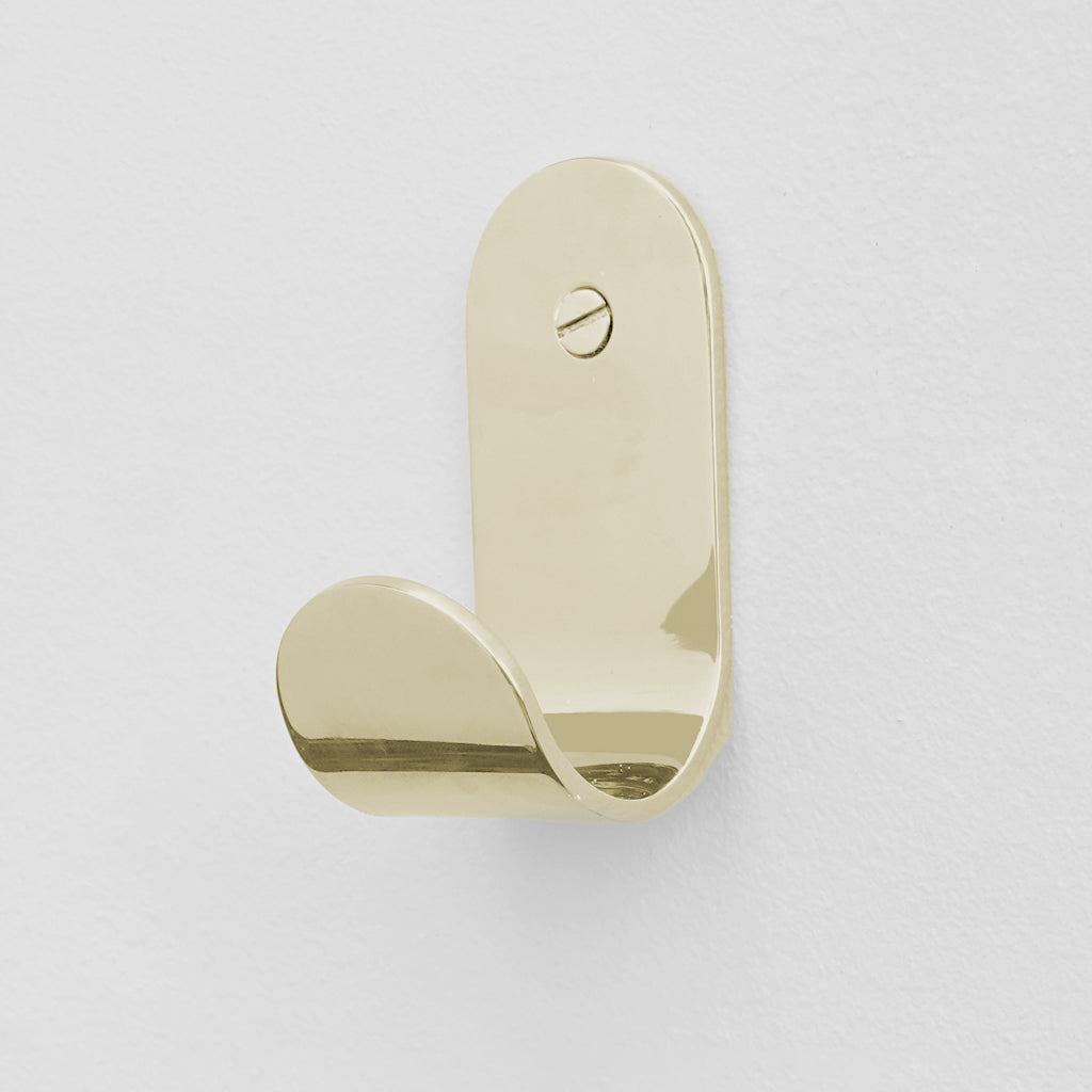 A CSSN BENDE Curve Hook door handle on a white wall.