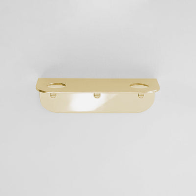 Bende Double Soap Holder in Mirrored Brass mounted on white wall with 3 slot head screws