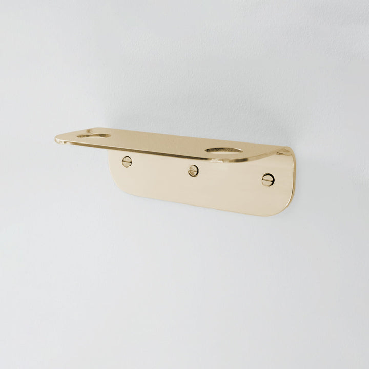 Bende Double Soap Holder in Mirrored Brass mounted on white wall with 3 slot head screws