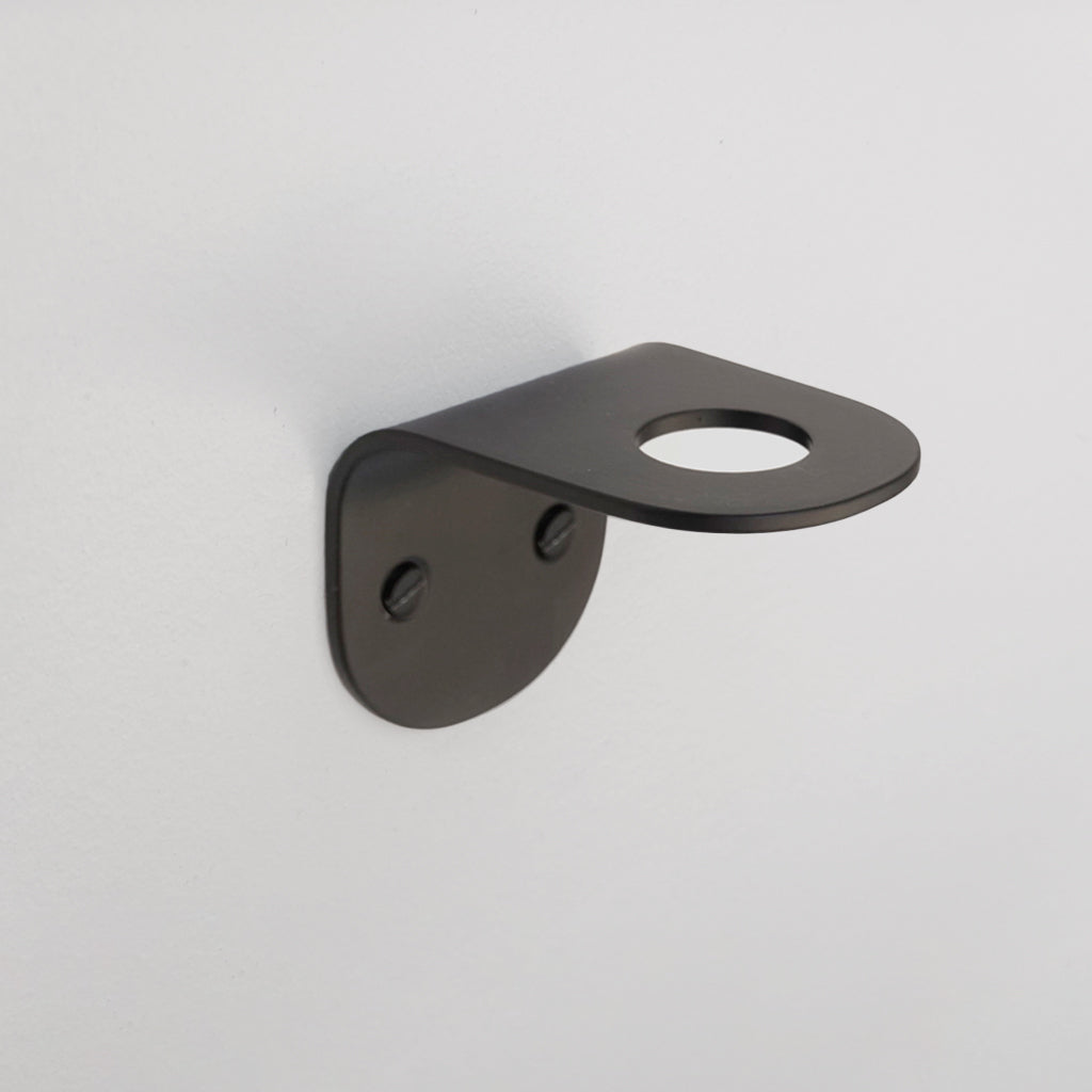 A close up of a CSSN BENDE Soap Holder Bracket Single on a wall.