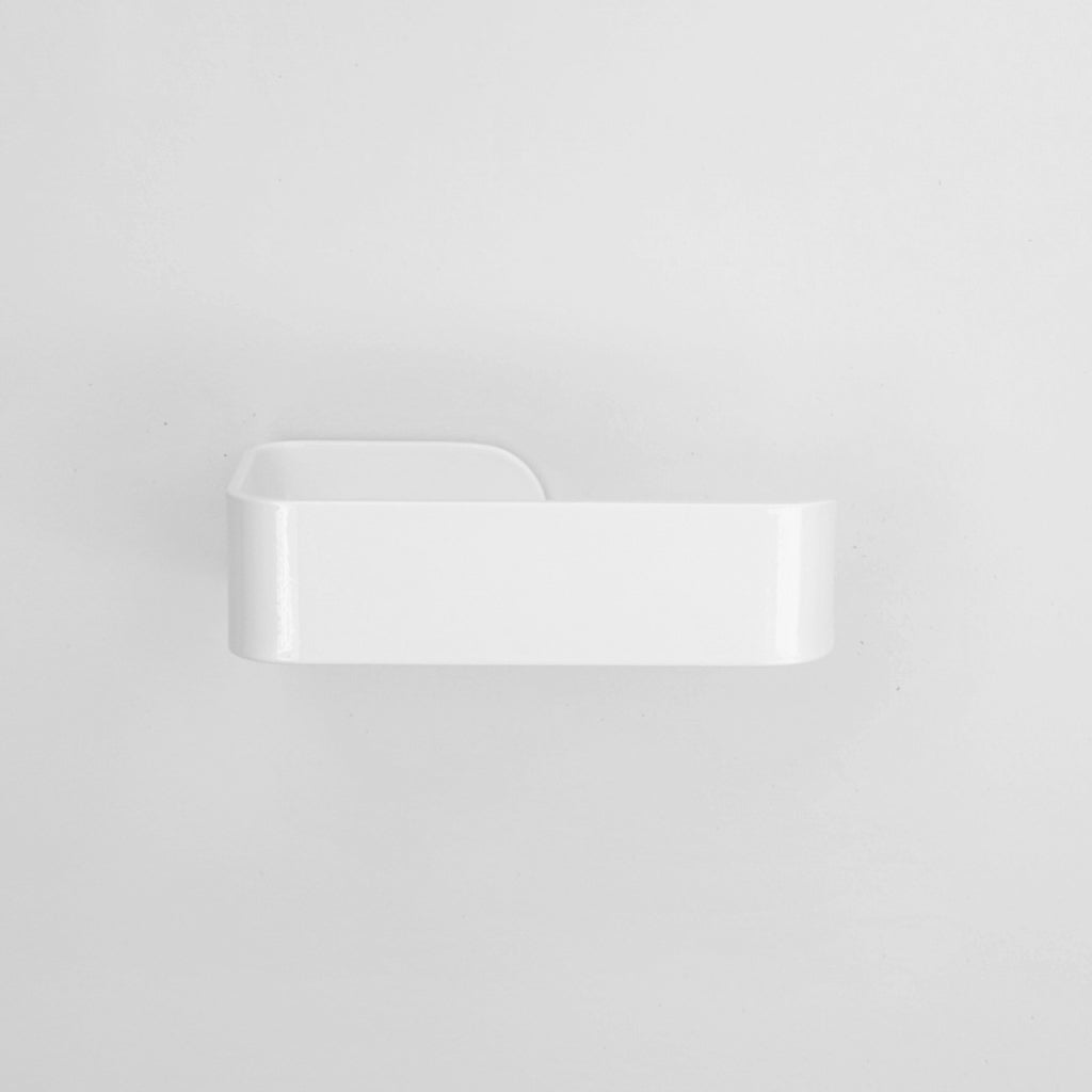 A close up of a CSSN BENDE Toilet Roll Holder on a wall.