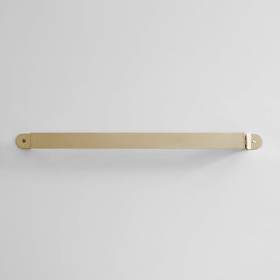 Bende Polished Brass Towel Bar Installed on white wall