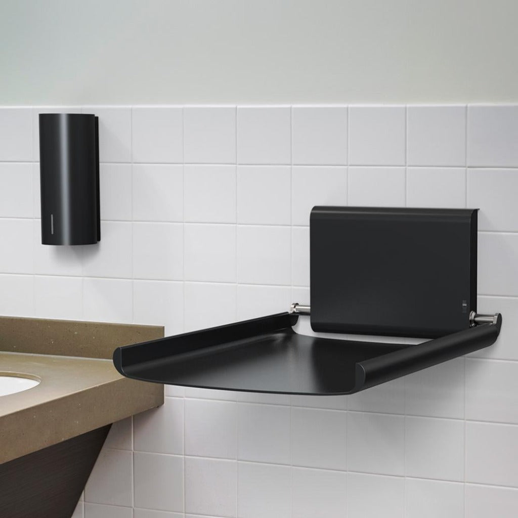 A bathroom with a Bjork Baby Changing Station and a Dan Dryer black shelf.