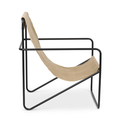 A Ferm Living Black Solid Desert Lounge Chair with a wooden seat and black frame.