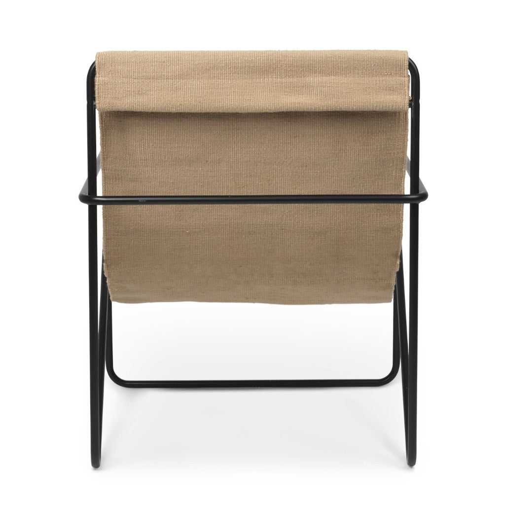 A beige Black Solid Desert Lounge Chair with a black frame by Ferm Living.